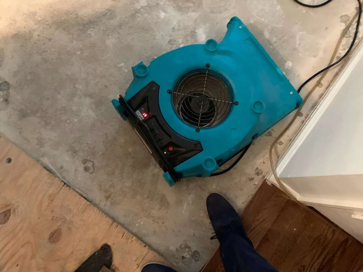 Air mover drying subfloor during Commercial Water Damage Restoration in Plumas Lake